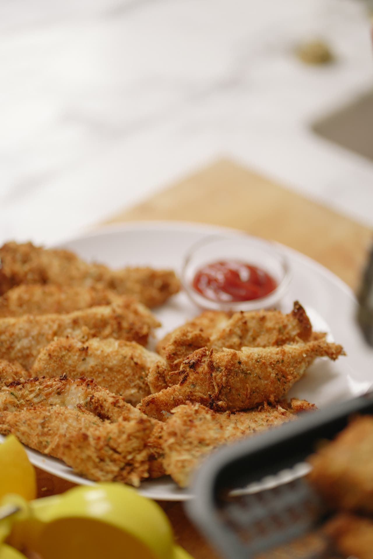 Crispy baked parmesan chicken tenders with ketchup
